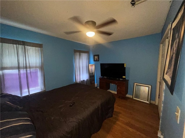 3034 Clouet St, New Orleans, LA 70126 - bedroom with dark wood-style floors, baseboards, and ceiling fan