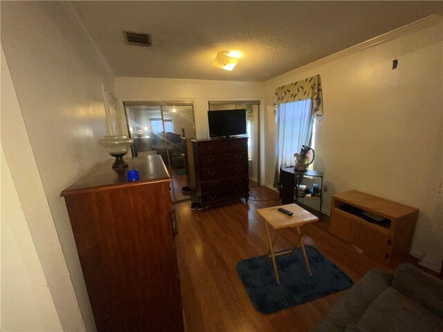 3034 Clouet St, New Orleans, LA 70126 - living area featuring wood finished floors, a textured ceiling, and ornamental molding