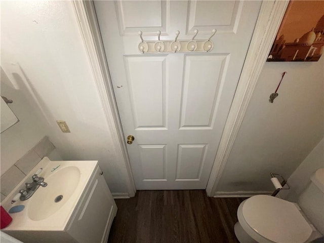 3034 Clouet St, New Orleans, LA 70126 - half bath with wood finished floors, vanity, and toilet