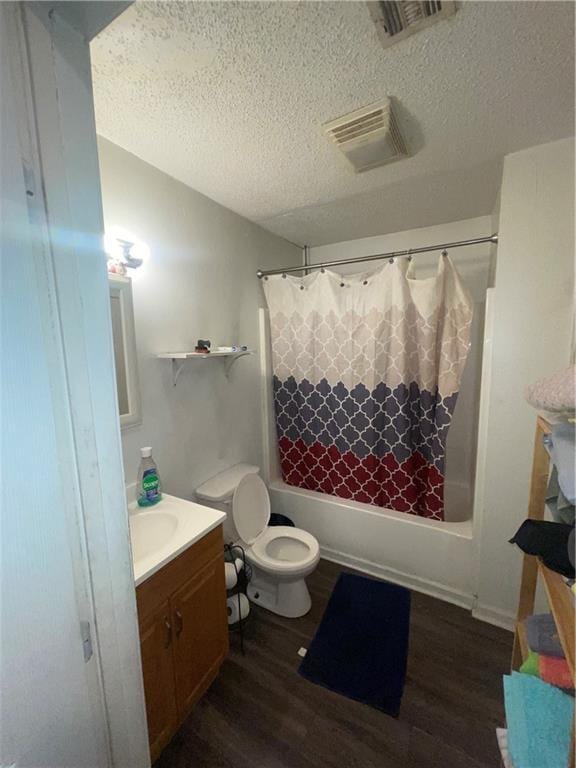 3034 Clouet St, New Orleans, LA 70126 - bathroom featuring vanity, wood finished floors, a textured ceiling, shower / bath combo, and toilet