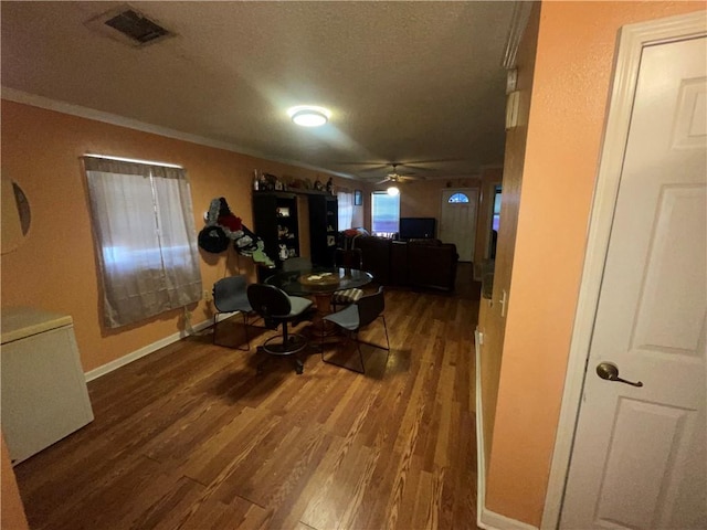 3034 Clouet St, New Orleans, LA 70126 - living area featuring a textured ceiling, wood finished floors, a ceiling fan, ornamental molding, and baseboards