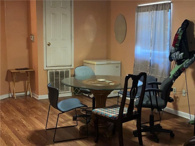 3034 Clouet St, New Orleans, LA 70126 - dining area featuring baseboards and wood finished floors