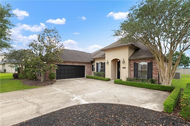 103 Lac Cypriere Dr, Luling, LA 70070 - view of front facade featuring brick siding, a garage, stucco siding, and driveway