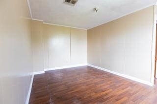 181113 Aubry St, New Orleans, LA 70116 - empty room featuring wood finished floors, baseboards, and ornamental molding