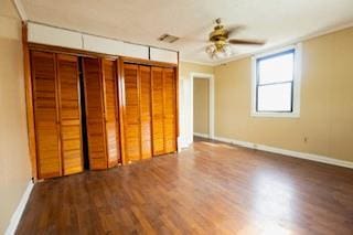 181113 Aubry St, New Orleans, LA 70116 - unfurnished bedroom with wood finished floors, baseboards, two closets, crown molding, and a ceiling fan