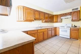 181113 Aubry St, New Orleans, LA 70116 - kitchen with white gas range, under cabinet range hood, light countertops, and brown cabinetry