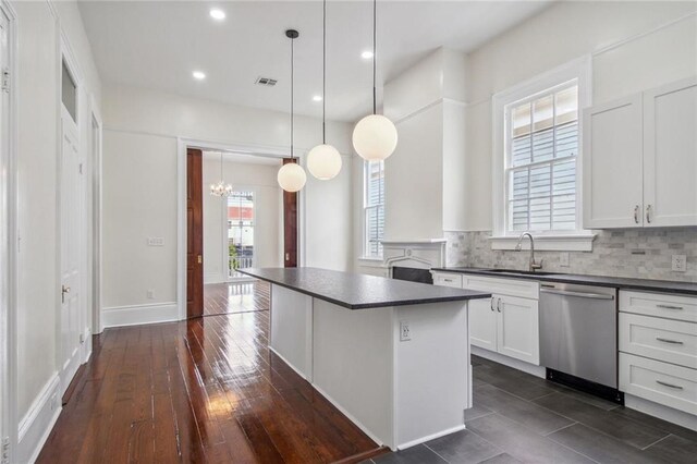 4628 Cleveland Ave, New Orleans, LA 70119 - kitchen with dishwasher, a sink, dark countertops, a chandelier, and a kitchen island