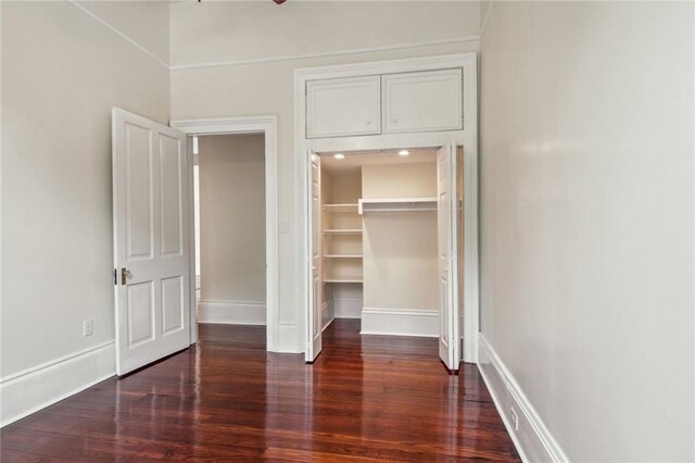 4628 Cleveland Ave, New Orleans, LA 70119 - unfurnished bedroom featuring wood finished floors, a closet, a spacious closet, and baseboards