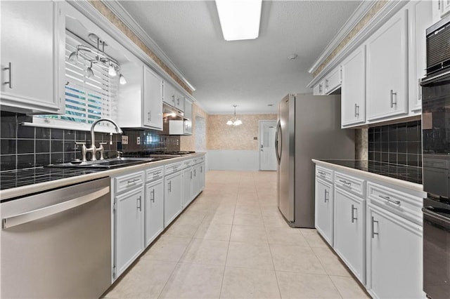 6242 Antioch Blvd, Baton Rouge, LA 70817 - kitchen with appliances with stainless steel finishes, tile counters, a sink, white cabinetry, and ornamental molding