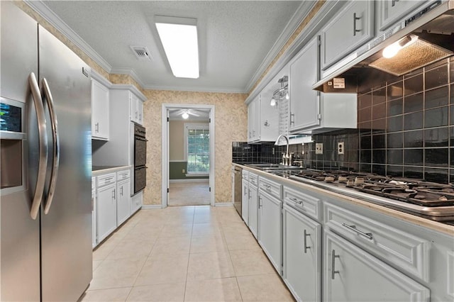 6242 Antioch Blvd, Baton Rouge, LA 70817 - kitchen featuring stainless steel appliances, a sink, crown molding, under cabinet range hood, and tasteful backsplash