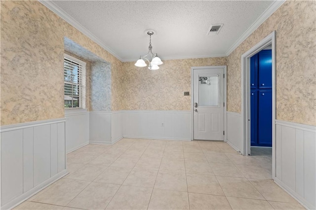6242 Antioch Blvd, Baton Rouge, LA 70817 - spare room with a chandelier, wainscoting, ornamental molding, a textured ceiling, and light tile patterned floors