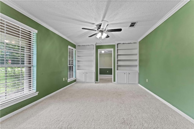 6242 Antioch Blvd, Baton Rouge, LA 70817 - carpeted spare room featuring ornamental molding, a textured ceiling, a ceiling fan, baseboards, and built in features