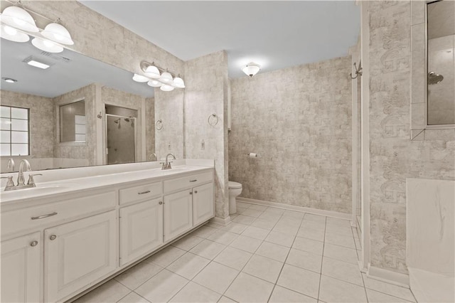 6242 Antioch Blvd, Baton Rouge, LA 70817 - full bathroom with tile patterned floors, double vanity, a shower stall, toilet, and baseboards