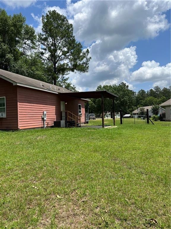 42984 River Birch Ln, Franklinton, LA 70438 - view of green lawn with central air condition unit and an attached carport