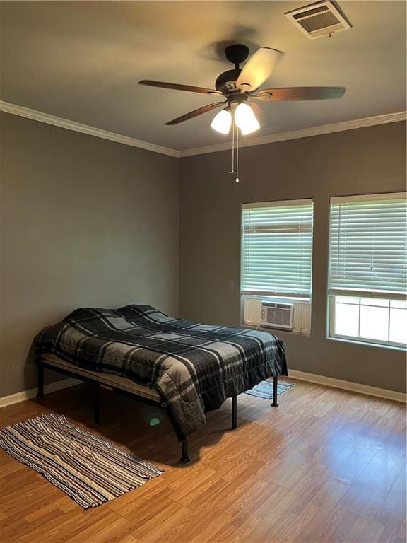 42984 River Birch Ln, Franklinton, LA 70438 - bedroom with wood finished floors, baseboards, crown molding, ceiling fan, and cooling unit