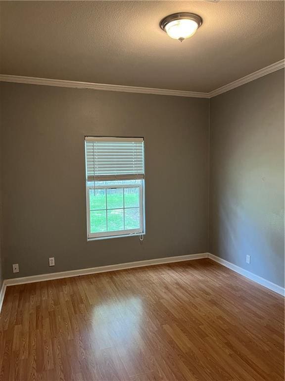 42984 River Birch Ln, Franklinton, LA 70438 - spare room featuring wood finished floors, crown molding, and baseboards