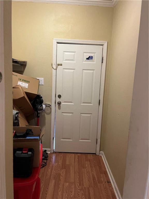 42984 River Birch Ln, Franklinton, LA 70438 - doorway to outside featuring wood finished floors and ornamental molding
