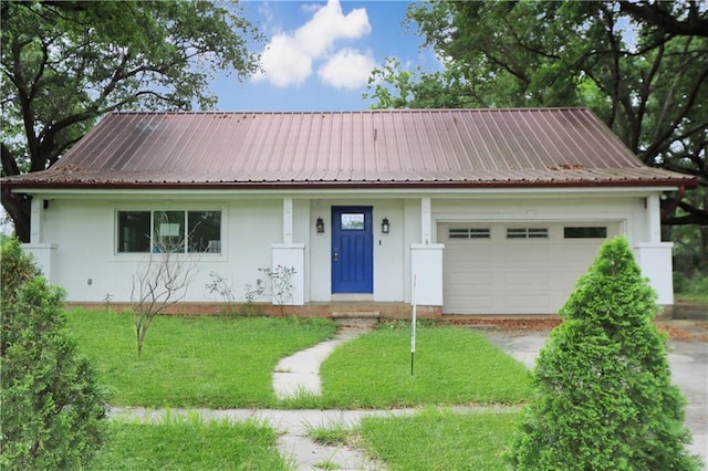 503 Park Blvd, Braithwaite, LA 70040 - ranch-style home featuring driveway, metal roof, an attached garage, a front lawn, and stucco siding