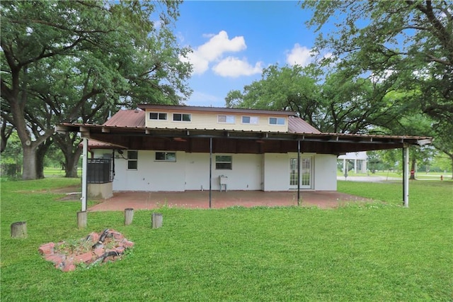 503 Park Blvd, Braithwaite, LA 70040 - back of property with a patio area, a lawn, and metal roof