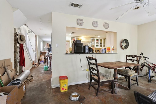4740 Banks St, New Orleans, LA 70119 - dining space featuring concrete floors, ceiling fan, and baseboards