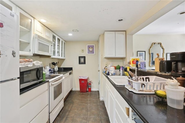 4740 Banks St, New Orleans, LA 70119 - kitchen with white appliances, a sink, dark countertops, glass insert cabinets, and white cabinetry