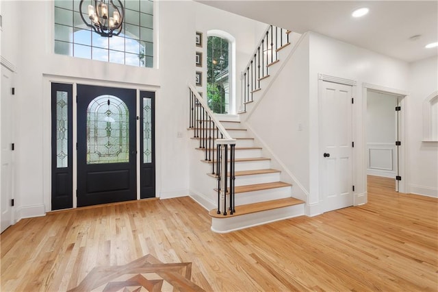 733 Plantation Dr, Abita Springs, LA 70420 - foyer entrance with wood finished floors, stairway, baseboards, a chandelier, and recessed lighting