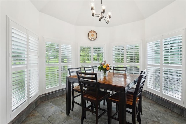 733 Plantation Dr, Abita Springs, LA 70420 - dining room featuring stone tile floors, a chandelier, and high vaulted ceiling