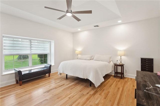 733 Plantation Dr, Abita Springs, LA 70420 - bedroom featuring light wood finished floors, baseboards, recessed lighting, a tray ceiling, and ceiling fan
