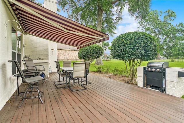 733 Plantation Dr, Abita Springs, LA 70420 - wooden deck featuring outdoor dining space and a grill