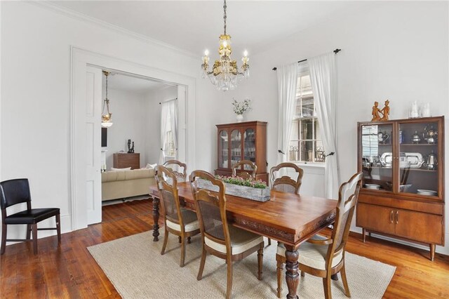 2728 Bell St, New Orleans, LA 70119 - dining space with plenty of natural light, a chandelier, wood finished floors, and ornamental molding