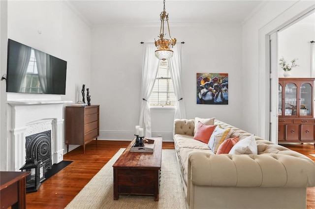 2728 Bell St, New Orleans, LA 70119 - living area featuring dark wood-type flooring, ornamental molding, a fireplace with flush hearth, and baseboards