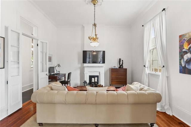 2728 Bell St, New Orleans, LA 70119 - living area with healthy amount of natural light, a fireplace, wood finished floors, and ornamental molding