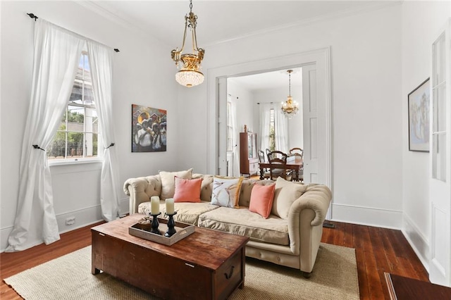 2728 Bell St, New Orleans, LA 70119 - living area featuring dark wood finished floors, a chandelier, crown molding, and baseboards