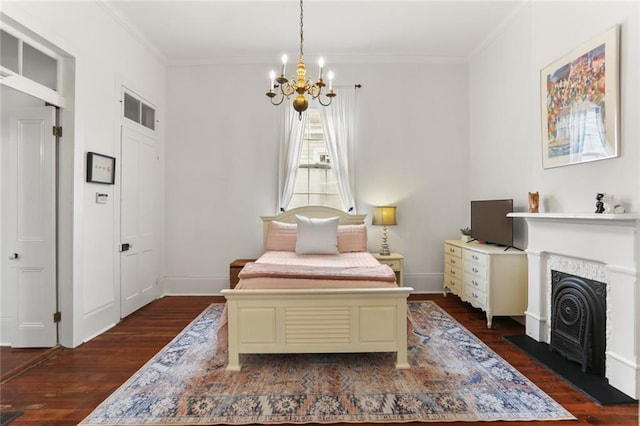 2728 Bell St, New Orleans, LA 70119 - bedroom featuring dark wood finished floors, a chandelier, ornamental molding, a fireplace with flush hearth, and baseboards