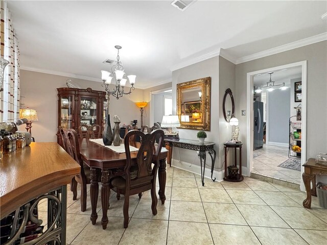 4153 W Loyola Dr, Kenner, LA 70065 - dining space featuring a chandelier, crown molding, light tile patterned floors, and baseboards