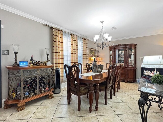 4153 W Loyola Dr, Kenner, LA 70065 - dining room featuring a chandelier, crown molding, tile patterned flooring, and baseboards