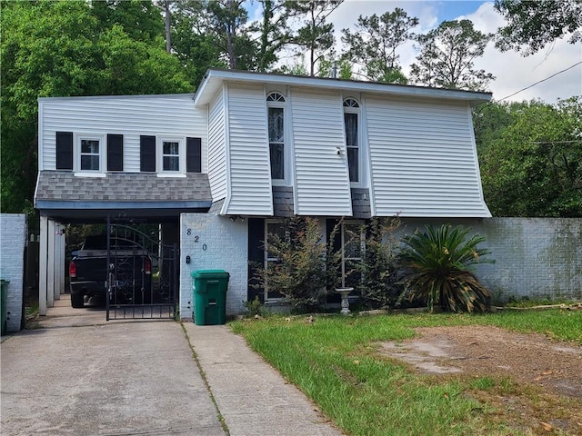 820 Hailey Ave, Slidell, LA 70458 - view of front of home with concrete driveway, brick siding, and a carport