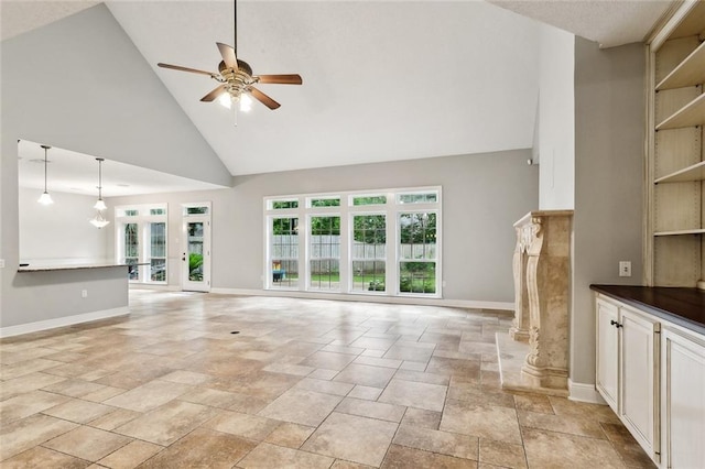 102 Ayshire Ct, Slidell, LA 70461 - unfurnished living room featuring high vaulted ceiling, a ceiling fan, stone tile floors, and baseboards