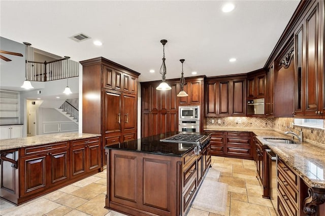 102 Ayshire Ct, Slidell, LA 70461 - kitchen featuring stainless steel appliances, a sink, a center island, stone tile flooring, and recessed lighting