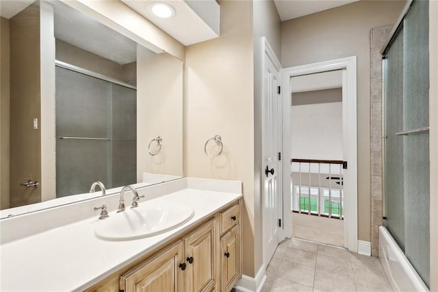102 Ayshire Ct, Slidell, LA 70461 - full bath featuring vanity, tile patterned flooring, baseboards, and bath / shower combo with glass door
