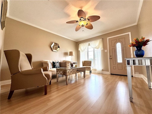 4608 Loveland St, Metairie, LA 70006 - sitting room featuring light wood finished floors, ornamental molding, a ceiling fan, baseboards, and a textured ceiling