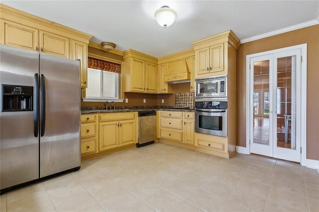 4608 Loveland St, Metairie, LA 70006 - kitchen featuring appliances with stainless steel finishes, french doors, wall chimney exhaust hood, a sink, and ornamental molding