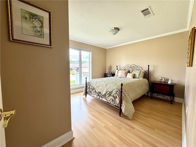4608 Loveland St, Metairie, LA 70006 - bedroom with crown molding, light wood-style flooring, baseboards, and a textured ceiling