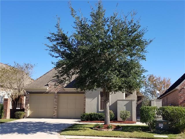 270 Nicklaus Dr, Slidell, LA 70458 - obstructed view of property featuring a garage, driveway, and stucco siding