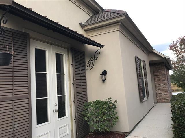 270 Nicklaus Dr, Slidell, LA 70458 - view of home's exterior with stucco siding and french doors