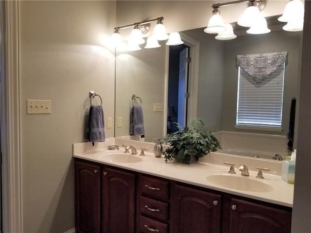 270 Nicklaus Dr, Slidell, LA 70458 - full bathroom with double vanity, a chandelier, and a bathtub