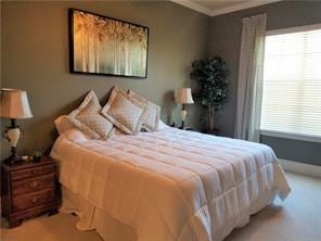 270 Nicklaus Dr, Slidell, LA 70458 - carpeted bedroom featuring multiple windows and crown molding