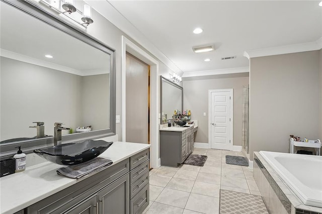 317 E Augusta Ln, Slidell, LA 70458 - bathroom featuring two vanities, crown molding, a stall shower, a garden tub, and tile patterned flooring