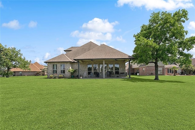 317 E Augusta Ln, Slidell, LA 70458 - rear view of house with a yard, brick siding, a patio area, and a shingled roof