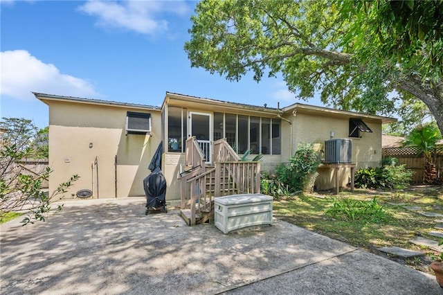 3845 Croydon St, Slidell, LA 70458 - rear view of property with a sunroom, stucco siding, a patio area, and brick siding